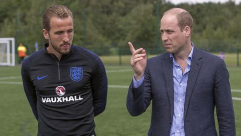 Britain's Prince William, right, talks to England's soccer team captain Harry Kane as he meets members of the England soccer team, during his visit to the FA training ground to meet players ahead of their friendly match against Costa Rica, in Leeds, England, Thursday, June 7, 2018. (Charlotte Graham/Pool Photo via AP)