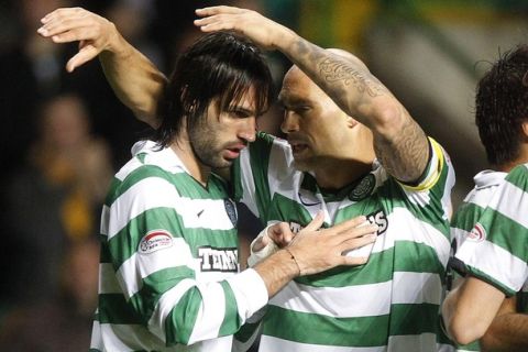 Celtic's Georgios Samaras (L) celebrates with teammate Daniel Majstorovic after scoring his hat trick of goals against Inverness Caley Thistle during their CIS Cup soccer match in Glasgow, Scotland September 22, 2010. REUTERS/David Moir (BRITAIN - Tags: SPORT SOCCER)