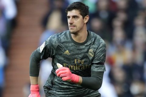 Real Madrid's goalkeeper Thibaut Courtois controls the ball during a Spanish La Liga soccer match between Real Madrid and Atletico Madrid at the Santiago Bernabeu stadium in Madrid, Saturday, Feb. 1, 2020. (AP Photo/Bernat Armangue)