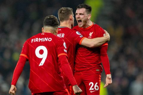  211220 -- LONDON, Dec. 20, 2021  -- Liverpool s Andy Robertson R celebrates scoring with teammates during the English Premier League match between Tottenham Hotspur and Liverpool in London, Britain, on Dec. 19, 2021.  FOR EDITORIAL USE ONLY. NOT FOR SALE FOR MARKETING OR ADVERTISING CAMPAIGNS. NO USE WITH UNAUTHORIZED AUDIO, VIDEO, DATA, FIXTURE LISTS, CLUB/LEAGUE LOGOS OR LIVE SERVICES. ONLINE IN-MATCH USE LIMITED TO 45 IMAGES, NO VIDEO EMULATION. NO USE IN BETTING, GAMES OR SINGLE CLUB/LEAGUE/PLAYER PUBLICATIONS. SPBRITAIN-LONDON-FOOTBALL-PREMIER LEAGUE-TOTTENHAM HOTSPUR VS LIVERPOOL Xinhua PUBLICATIONxNOTxINxCHN