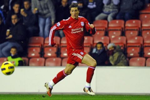 Liverpool's Spanish forward Fernando Torres in action during the English Premier League football match between Wigan Athletic and Liverpool at The DW Stadium, Wigan, north-west England on November 10, 2010. AFP PHOTO/PAUL ELLIS.FOR  EDITORIAL USE Additional licence required for any commercial/promotional use or use on TV or internet (except identical online version of newspaper) of Premier League/Football League photos. Tel DataCo +44 207 2981656. Do not alter/modify photo (Photo credit should read PAUL ELLIS/AFP/Getty Images)