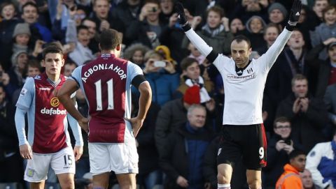 Fulham's Dimitar Berbatov, right, celebrates his penalty goal against Aston Villa during their English Premier League soccer match at Craven Cottage, London, Sunday, Dec. 8, 2013. (AP Photo/Sang Tan)