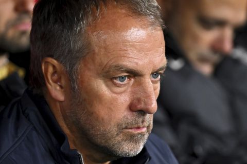 Barcelona's head coach Hansi Flick sits at the bench during a Spanish La Liga soccer match between Osasuna and Barcelona at El Sadar stadium in Pamplona, Spain, Saturday, Sept. 28, 2024. (AP Photo/Miguel Oses)