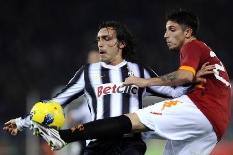 AS Roma's midfielder Leandro Greco (L) vies with Juventus midfielder Andrea Pirlo during their Italian Serie A football match in Rome's Olympic Stadium on December 12, 2011. AFP PHOTO / Filippo MONTEFORTE (Photo credit should read FILIPPO MONTEFORTE/AFP/Getty Images)