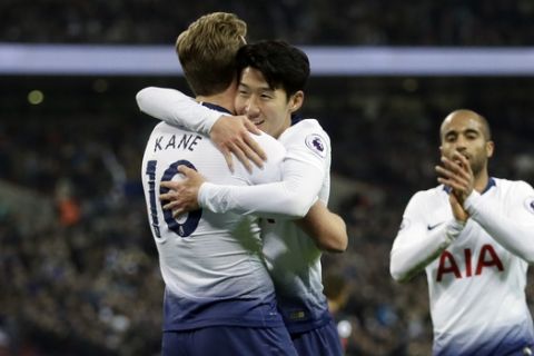 Tottenham's Heung-Min Son, center, celebrates with Harry Kane after scoring his side's fifth goal during the English Premier League soccer match between Tottenham Hotspur and Bournemouth at Wembley stadium in London, Wednesday, Dec. 26, 2018. (AP Photo/Tim Ireland)