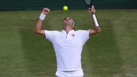 Switzerland's Roger Federer celebrates after beating Spain's Rafael Nadal in a Men's singles semifinal match on day eleven of the Wimbledon Tennis Championships in London, Friday, July 12, 2019. (Andy Couldridge/Pool Photo via AP)