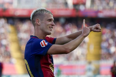 Barcelona's Dani Olmo celebrates scoring his side's 6th goal during the Spanish La Liga soccer match between FC Barcelona and Valladolid at the Olympic stadium in Barcelona, Spain, Saturday, Aug. 31, 2024. (AP Photo/Joan Monfort)