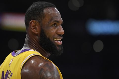 Los Angeles Lakers forward LeBron James stands on the court during the first half of an NBA basketball game against the Philadelphia 76ers Tuesday, March 3, 2020, in Los Angeles. (AP Photo/Mark J. Terrill)