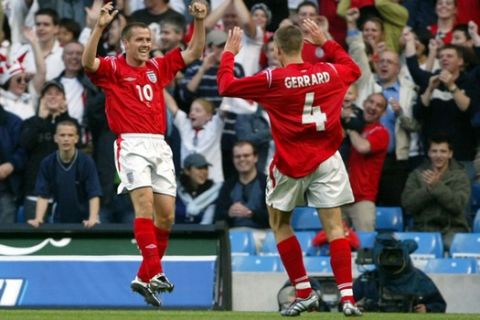 England's Michael Owen celebrates scoring against Japan with Steven Gerrard during their soccer game at the City of Manchester Stadium, Manchester, England, Tuesday, June 1, 2004. (AP Photo/Paul Ellis)