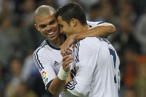 Real Madrid's Cristiano Ronaldo from Portugal, right, celebrates his goal with, Pepe from Portugal, left, during a Spanish La Liga soccer match against Deportivo la Coruna at the Santiago Bernabeu stadium in Madrid, Spain, Sunday, Sept. 30, 2012. (AP Photo / Andres Kudacki)