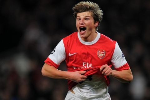 Arsenal's Russian midfielder Andrey Arshavin celebrates after scoring a goal during his team's Champions League round of 16, 1st leg football match against FC Barcelona on February 16, 2011 at the Emirates Stadium in London. AFP PHOTO/LLUIS GENE. (Photo credit should read LLUIS GENE/AFP/Getty Images)