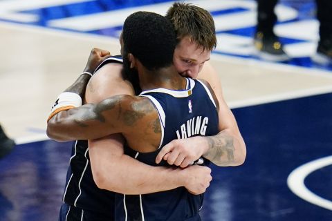 Dallas Mavericks guard Luka Doncic, left, and guard Kyrie Irving, right, embrace after their win over theMinnesota Timberwolves in Game 3 of the NBA basketball Western Conference finals, Sunday, May 26, 2024, in Dallas. (AP Photo/Gareth Patterson)