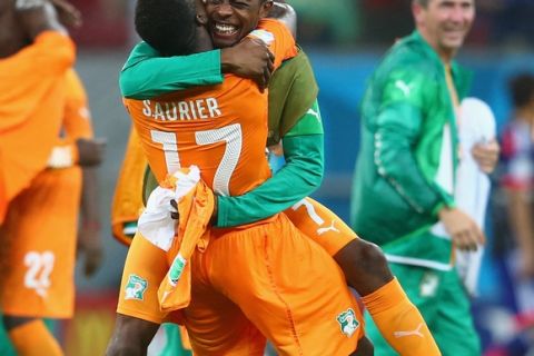 RECIFE, BRAZIL - JUNE 14: Serge Aurier of the Ivory Coast (L) and Jean-Daniel Akpa-Akpro of the Ivory Coast hug after defeating Japan 2-1 during the 2014 FIFA World Cup Brazil Group C match  between the Ivory Coast and Japan at Arena Pernambuco on June 14, 2014 in Recife, Brazil.  (Photo by Julian Finney/Getty Images)