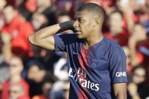 PSG's Kylian Mbappe reacts as he walks out to the pitch received the red cart during their League One soccer match between Nimes and Paris Saint-Germain at Jean-Bouin stadium in Nimes, southern France, Saturday Sept. 1, 2018. (AP Photo/Claude Paris)