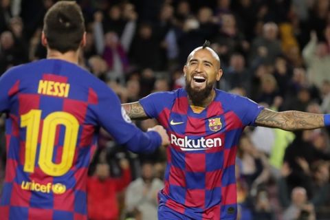 Barcelona's Arturo Vidal,right, celebrates with Barcelona's Lionel Messi, left, just before the goal was disallowed during a Champions League group F soccer match between Barcelona and Slavia Praha at Camp Nou stadium in Barcelona, Spain, Tuesday, Nov. 5, 2019. The goal was disallowed for off-side. (AP Photo/Emilio Morenatti)