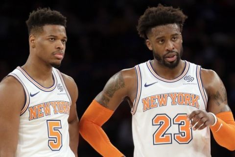 New York Knicks' Wesley Matthews, right, and Dennis Smith Jr. talk during the second half of an NBA basketball game against the Memphis Grizzlies, Sunday, Feb. 3, 2019, in New York. (AP Photo/Seth Wenig)