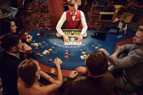 Group of people gambling sitting at a table in a casino top view. Betting gambling.