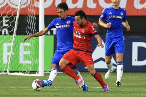 NEW YORK, NY - JULY 22: Ezequiel Lavezzi #11 of Paris Saint Germain and Paulo Ferreira #19 of Chelsea FC battle for the ball during the match at Yankee Stadium on July 22, 2012 in New York City.  (Photo by Andy Marlin/Getty Images)