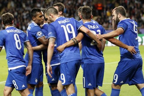 Juventus' Gonzalo Higuain, right, celebrates with his teammates after scoring during the Champions League semifinal first leg soccer match between Monaco and Juventus at the Louis II stadium in Monaco, Wednesday, May 3, 2017. (AP Photo/Claude Paris)