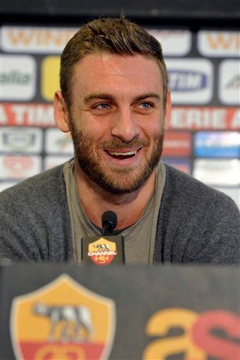 AS Roma midfielder Daniele De Rossi smiles as he meets the media after announcing he signed a five-year contract extension with his team, in Rome, Monday, Feb. 6, 2012. (AP Photo/Alfredo Falcone, Lapresse)