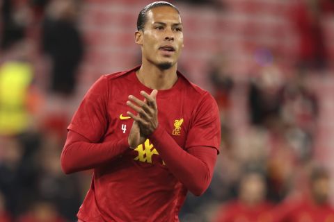 Liverpool's Virgil van Dijk warms up prior to the Champions League soccer match between Liverpool and Bologna at the Anfield stadium in Liverpool, England, Wednesday, Oct. 2, 2024. (AP Photo/Ian Hodgson)