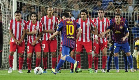 Barcelona's Argentinian forward Lionel Messi shoots the ball on a free-kick during the Spanish league football match FC Barcelona vs Atletico de Madrid on September 24, 2011 at the Camp Nou stadium in Barcelona.   AFP PHOTO/ JOSEP LAGO (Photo credit should read JOSEP LAGO/AFP/Getty Images)