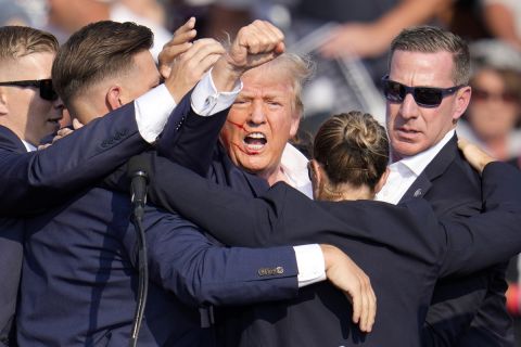 Republican presidential candidate former President Donald Trump is helped off the stage by U.S. Secret Service agents at a campaign event in Butler, Pa., on Saturday, July 13, 2024. (AP Photo/Gene J. Puskar)