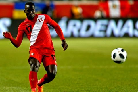 In this photo taken on Tuesday, March 27, 2018 Peru defender Luis Advincula in action against Iceland during the second half of an international friendly soccer match Tuesday, in Harrison, N.J. (AP Photo/Adam Hunger)