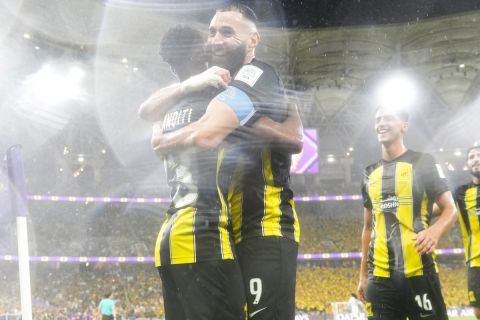 Al Ittihad's Karim Benzema, second left, celebrates with teammates under a heavy rain after scoring their side's third goal during the Soccer Club World Cup first round soccer match between Al Ittihad and Auckland City FC at King Abdullah Sports City stadium in Jeddah, Saudi Arabia, Tuesday, Dec. 12, 2023. (AP Photo/Manu Fernandez)