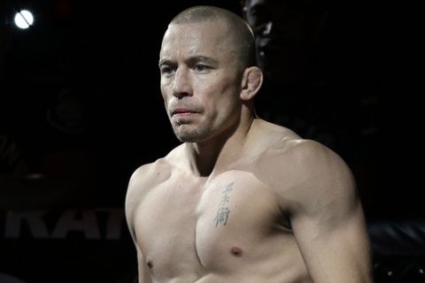 Georges St. Pierre, of Canada, waits to begin a UFC 167 mixed martial arts championship welterweight bout against Johny Hendricks on Saturday, Nov. 16, 2013, in Las Vegas. St. Pierre won by split decision. (AP Photo/Isaac Brekken)