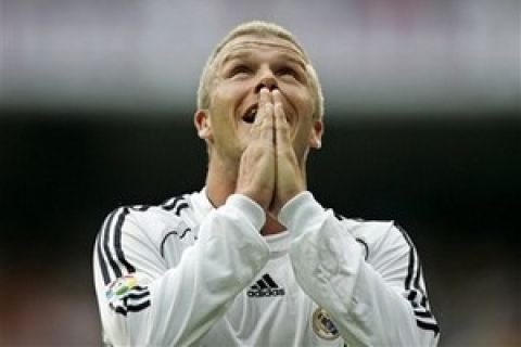 Real Madrid's David Beckham of England reacts after receiving a yellow card during a Spanish league match against Deportivo la Coruna at the Santiago Bernabau stadium in Madrid, Saturday, May 26, 2007. Beckham, who will move to the MLS with the Los Angeles Galaxy next month, was selected in England's 26-man squad Saturday for the first time since last year's World Cup in Germany. (AP Photo/Paul White)