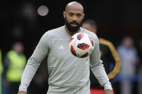 Belgium assistant coach Thierry Henry eyes the ball prior to the semifinal match between France and Belgium at the 2018 soccer World Cup in the St. Petersburg Stadium, in St. Petersburg, Russia, Tuesday, July 10, 2018. (AP Photo/Petr David Josek)