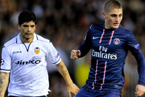 Valencia's Argentinian midfielder Ever Banega (L) vies with PSG's Serbian midfielder Milan Bisevac (R) during the UEFA Champions League round of 16 first leg football match Valencia CF vs Paris Saint Germain at the Mestalla stadium in Valencia on February 12, 2013.   AFP PHOTO/ JOSEP LAGO        (Photo credit should read JOSEP LAGO/AFP/Getty Images)