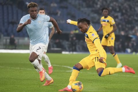 Atalanta's Ademola Lookman, right, duels for the ball with Lazio's Fisayo Dele-Bashiru during a Serie A soccer match between Lazio and Atalanta, at the Stadio Olimpico in Rome, Italy, Saturday, Dec. 28, 2024. (AP Photo/Alessandra Tarantino)