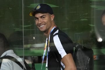 Saudi Arabian Al Nassr's Cristiano Ronaldo, center, smiles as he arrives at the Azadi Stadium prior to the AFC Champions League soccer match against Iran's Persepolis in Tehran, Iran, Tuesday, Sept. 19, 2023. (AP Photo/Vahid Salemi)