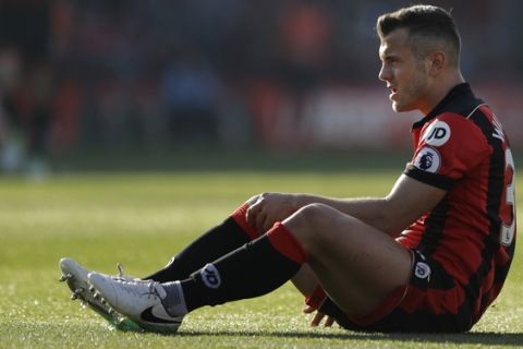 Bournemouth's Jack Wilshere sits on the turf after being fouled during their English Premier League soccer match between Bournemouth and Chelsea at Dean Court stadium in Bournemouth, England, Saturday, April 8, 2017. (AP Photo/Matt Dunham)