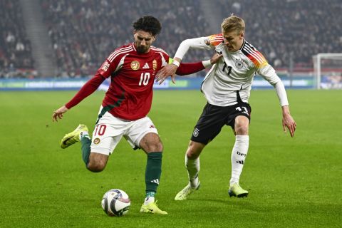 Hungary's Dominik Szoboszlai challenges for the ball with Germany's Chris Fuhrich during the Nations League soccer match between Hungary and Germany at the Puskas Arena stadium in Budapest, Tuesday, Nov. 18, 2024. (AP Photo/Denes Erdos)