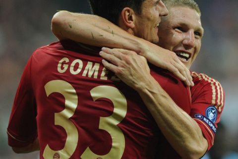 Bayern Munich's striker Mario Gomez (L) is congratulated by his teammate Bayern Munich's midfielder Bastian Schweinsteiger after scoring the 2-0 during the Champions League group A  match of German first division football club Bayern Munich against England's Premier League club Manchester City on September 27, 2011 in Munich, southern Germany.       AFP PHOTO / CHRISTOF STACHE (Photo credit should read CHRISTOF STACHE/AFP/Getty Images)