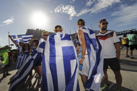 FORTALEZA, BRAZIL - JUNE 24: Fans arrive at Arena Castelao stadium for the Greece v Cote D'Ivoire: Group C match during the 2014 FIFA World Cup Brazil on June 24, 2014 in Fortaleza, Brazil. (Photo by Drawlio Joca/Getty Images)