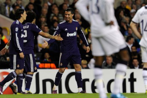 Real Madrid's Portugese player Cristiano Ronaldo (C) celebrates scoring a goal against Tottenham Hotspur with Real Madrid's Brazilian player Marcelo (2nd L) during a UEFA Champions League Quarter Final, 2nd leg football match at White Hart Lane, London on April 13, 2011.  AFP PHOTO / JAVIER SORIANO (Photo credit should read JAVIER SORIANO/AFP/Getty Images)