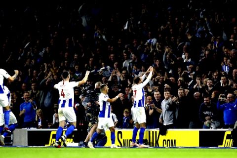 Brighton &'s Glenn Murray celebrates scoring his side's first goal of the game during the English Premier League soccer match between Brighton and West Ham united, at the AMEX Stadium, in  Brighton, England, Friday Oct. 5, 2018. (Gareth Fuller/PA via AP)