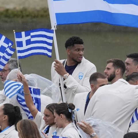 The boat carrying team Greece, with basketball player Giannis Antetokounmpo, center back, makes its way down the Seine in Paris, France, during the opening ceremony of the 2024 Summer Olympics, Friday, July 26, 2024. (AP Photo/Rebecca Blackwell)