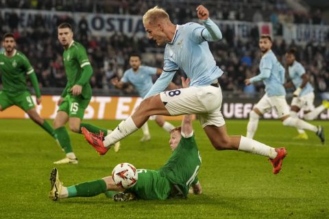 Lazio's Gustav Isaksen, top, and Ludogorets' Aslak Fonn Witry fight for the ball during an Europa League soccer match between Lazio and Ludogorets, at Rome's Olympic Stadium, Thursday, Nov. 28, 2024. (AP Photo/Andrew Medichini)