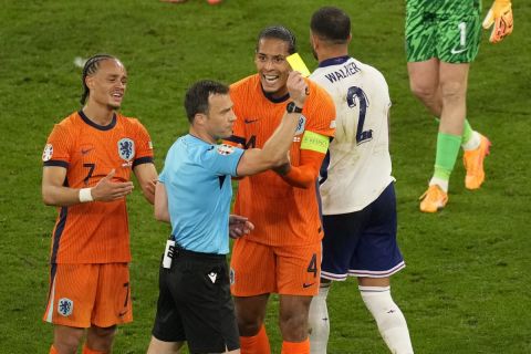 Virgil van Dijk of the Netherlands sees the yellow card during a semifinal match between the Netherlands and England at the Euro 2024 soccer tournament in Dortmund, Germany, Wednesday, July 10, 2024. (AP Photo/Andreea Alexandru)