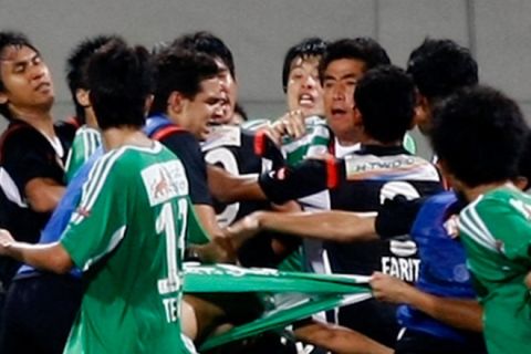 S-League football match: Beijing Guoan (in green) vs Young Lions (in black) at the Jalan Besar Stadium. A melee broke out in the Beijing penalty box after two of the foreign teams players were floored in a challenge. With both sets of players separated and confined within their dugouts, the team managers met with the referee, who decided then to call the game off.