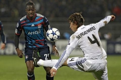 Real Madrid's Sergio Ramos of Spain, right, competes for the ball with Lyon's Aly Cissokho of France during their Champions League soccer match, in Lyon stadium, central France, Tuesday, Feb. 22, 2011. (AP Photo/Laurent Cipriani)