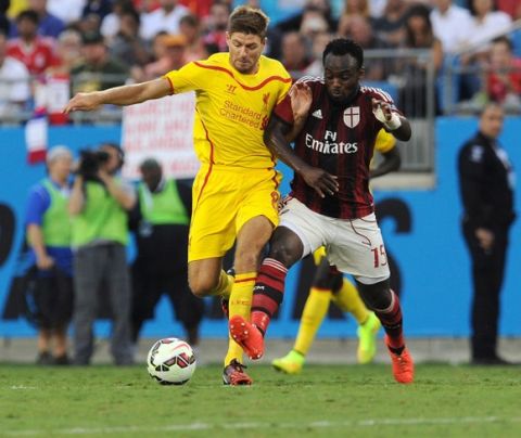 CHARLOTTE, NC - AUGUST 02:  (THE SUN OUT & THE SUN ON SUNDAY OUT) Steven Gerrard of Liverpool competes with Michael Essien of AC Milan during the International Champions Cup 2014 match against Liverpool and AC Milan at Bank of America Stadium on August 2, 2014 in Charlotte, North Carolina.  (Photo by John Powell/Liverpool FC via Getty Images)