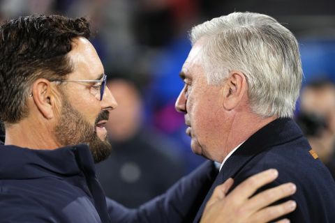 Getafe's head coach Jose Bordalas, left, talks to Real Madrid's head coach Carlo Ancelotti prior the start of the Spanish La Liga soccer match between Getafe and Real Madrid at the Coliseum Alfonso Perez stadium in Getafe, Spain, Thursday, Feb. 1, 2024. (AP Photo/Manu Fernandez)