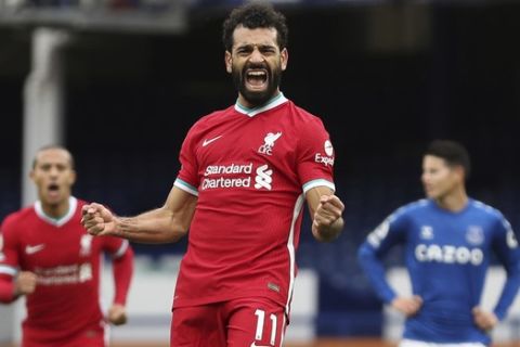 Liverpool's Mohamed Salah, 11, celebrates scoring his side's second goal during the English Premier League soccer match between Everton and Liverpool at Goodison Park stadium, in Liverpool, England, Saturday, Oct. 17, 2020. (Cath Ivill/Pool via AP)