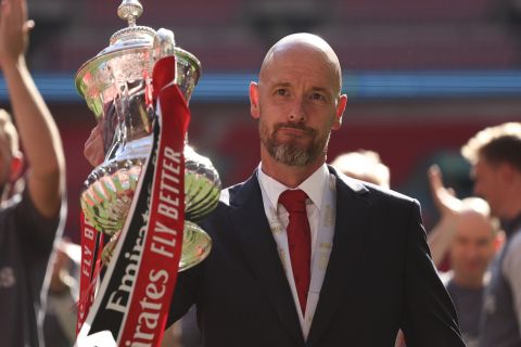 FILE - Manchester United's head coach Erik ten Hag celebrates with the trophy after winning the English FA Cup final soccer match between Manchester City and Manchester United at Wembley Stadium in London, on May 25, 2024. Manchester United manager Erik ten Hag has signed a contract extension through to 2026, the Premier League club said. (AP Photo/Ian Walton)